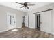 Spacious bedroom boasting wood floors, a modern ceiling fan, and ample natural light at 1952 Lewis Dr, Burlington, NC 27215