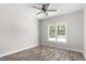 Bright bedroom featuring luxury vinyl plank flooring, ceiling fan, and large window at 1952 Lewis Dr, Burlington, NC 27215