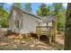 Home featuring a back deck, white siding, and a gray roof at 1952 Lewis Dr, Burlington, NC 27215