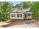 Charming exterior view of a home with white siding, brick foundation, and a covered front porch at 1952 Lewis Dr, Burlington, NC 27215