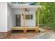 View of a cozy front porch featuring wood columns, a ceiling fan, and classic exterior lighting at 1952 Lewis Dr, Burlington, NC 27215