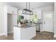 Bright kitchen with white cabinets, a granite island, stainless appliances, and modern pendant lighting at 1952 Lewis Dr, Burlington, NC 27215