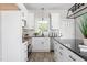 Bright kitchen featuring white cabinets, dark countertops, and stainless steel appliances at 1952 Lewis Dr, Burlington, NC 27215