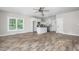 Open-concept living area with a kitchen island, wood floors, and plentiful natural light at 1952 Lewis Dr, Burlington, NC 27215