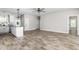 Expansive living area boasts wood floors, a ceiling fan, and natural light, flowing into the kitchen at 1952 Lewis Dr, Burlington, NC 27215