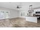 Bright living space featuring wood floors, ceiling fan, modern light fixtures, and sliding glass doors to the outside at 1952 Lewis Dr, Burlington, NC 27215
