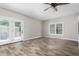 Bright open living space with sliding glass doors and a large window for natural light with wood flooring at 1952 Lewis Dr, Burlington, NC 27215