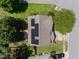 This aerial view showcases a home with solar panels, surrounded by lush greenery in a suburban neighborhood at 2037 Summer Shire Way, Raleigh, NC 27604