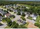 Aerial view of homes in a neighborhood with mature trees in a home listing at 2037 Summer Shire Way, Raleigh, NC 27604
