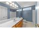 Bathroom with wood cabinet, white countertop, shower, and toilet in a home listing at 2037 Summer Shire Way, Raleigh, NC 27604