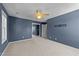 Empty bedroom in blue with carpet features a fan, window and sliding closet doors at 2037 Summer Shire Way, Raleigh, NC 27604