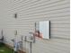 Exterior detail of a home showing a Tesla power inverter in a home listing at 2037 Summer Shire Way, Raleigh, NC 27604