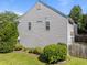 Side view of a home with vinyl siding, landscaping, and green grass in a home listing at 2037 Summer Shire Way, Raleigh, NC 27604