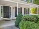 Inviting front porch with a dark front door and manicured landscaping at 2037 Summer Shire Way, Raleigh, NC 27604