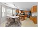 Eat-in kitchen featuring a large table, lots of windows, wood cabinets and stainless appliances at 2037 Summer Shire Way, Raleigh, NC 27604