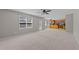 Spacious living room that opens to the kitchen boasts large windows for ample natural light and ceiling fan at 2037 Summer Shire Way, Raleigh, NC 27604