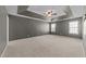 Unfurnished main bedroom features neutral carpet, tray ceiling, fan and two windows for natural light at 2037 Summer Shire Way, Raleigh, NC 27604
