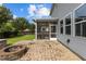 This backyard has a screened porch, a paved patio and a stone fire pit for an outdoor entertainment space at 209 S Harrison Place Ln, Fuquay Varina, NC 27526