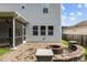 Backyard showcasing a screened porch, paved patio and stone fire pit to enhance your outdoor experience at 209 S Harrison Place Ln, Fuquay Varina, NC 27526