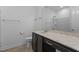 Well-lit bathroom featuring a vanity with dark wood cabinets and a large mirror at 209 S Harrison Place Ln, Fuquay Varina, NC 27526