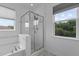 Bathroom featuring soaking tub, glass shower, and natural light at 209 S Harrison Place Ln, Fuquay Varina, NC 27526