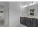 Bathroom with double vanity, large mirror, and tile flooring at 209 S Harrison Place Ln, Fuquay Varina, NC 27526