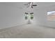 Spacious bedroom with three windows, neutral carpeting and ceiling fan at 209 S Harrison Place Ln, Fuquay Varina, NC 27526