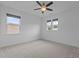 Bright bedroom with neutral carpet, ceiling fan and two windows that provide ample natural light at 209 S Harrison Place Ln, Fuquay Varina, NC 27526