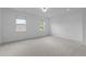 Bedroom featuring large windows and neutral carpet at 209 S Harrison Place Ln, Fuquay Varina, NC 27526