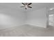Large bedroom featuring plush carpet flooring, ceiling fan, ensuite bathroom and closet at 209 S Harrison Place Ln, Fuquay Varina, NC 27526