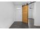 View of the entryway and sliding wood door to a bedroom, showcasing the modern design at 209 S Harrison Place Ln, Fuquay Varina, NC 27526