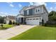 Charming two-story home with a two-car garage, well-manicured lawn, and beautiful landscaping at 209 S Harrison Place Ln, Fuquay Varina, NC 27526
