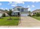 Charming two-story home with a two-car garage, well-manicured lawn, and beautiful landscaping at 209 S Harrison Place Ln, Fuquay Varina, NC 27526