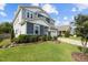 Charming two-story home with landscaped front yard featuring lush green lawn and decorative shrubs at 209 S Harrison Place Ln, Fuquay Varina, NC 27526