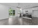 Modern kitchen features an island, stainless steel appliances, white cabinets and backyard access at 209 S Harrison Place Ln, Fuquay Varina, NC 27526