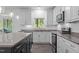Bright kitchen with stainless steel appliances, ample counter space, and a view of the backyard at 209 S Harrison Place Ln, Fuquay Varina, NC 27526