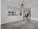 Spacious living room featuring modern flooring and ample natural light, offering a welcoming atmosphere at 209 S Harrison Place Ln, Fuquay Varina, NC 27526