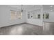 Spacious living room featuring modern flooring and ample natural light, offering a welcoming atmosphere at 209 S Harrison Place Ln, Fuquay Varina, NC 27526
