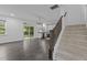Spacious living room with dark wood floors, stairs, and an open view to the kitchen at 209 S Harrison Place Ln, Fuquay Varina, NC 27526