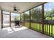 Covered screened in porch equipped with ceiling fan and grill with scenic views at 209 S Harrison Place Ln, Fuquay Varina, NC 27526