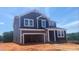 Charming two-story home with a two-car garage, blue siding and white trim, exuding modern elegance at 216 Sprenger St, Garner, NC 27529