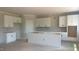 Spacious kitchen with white cabinets and an island, ready for customization and modern appliances at 216 Sprenger St, Garner, NC 27529