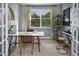 Stylish home office with patterned wallpaper, large window, desk, and a modern chair at 216 Sprenger St, Garner, NC 27529