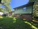 View of the backyard featuring green lawn and the exterior walls of the house at 2308 Blacklan Cir, Raleigh, NC 27610