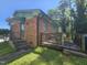 A brick home featuring a quaint deck area and convenient accessibility from the side entrance at 2308 Blacklan Cir, Raleigh, NC 27610