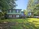 Charming two-story home with a brick facade and a well-manicured lawn in a shady neighborhood at 2308 Blacklan Cir, Raleigh, NC 27610