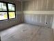 Spacious bedroom featuring modern window framing and unfinished drywall for customization at 240 Noramac Ct, Selma, NC 27576