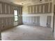 A living room under construction with drywall installed and a window to the outside at 240 Noramac Ct, Selma, NC 27576