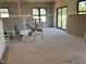 A large living room under construction with a sliding glass door and many windows at 240 Noramac Ct, Selma, NC 27576