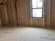 Wood-framed unfinished room with a window, showcasing construction elements for a customizable area at 240 Noramac Ct, Selma, NC 27576